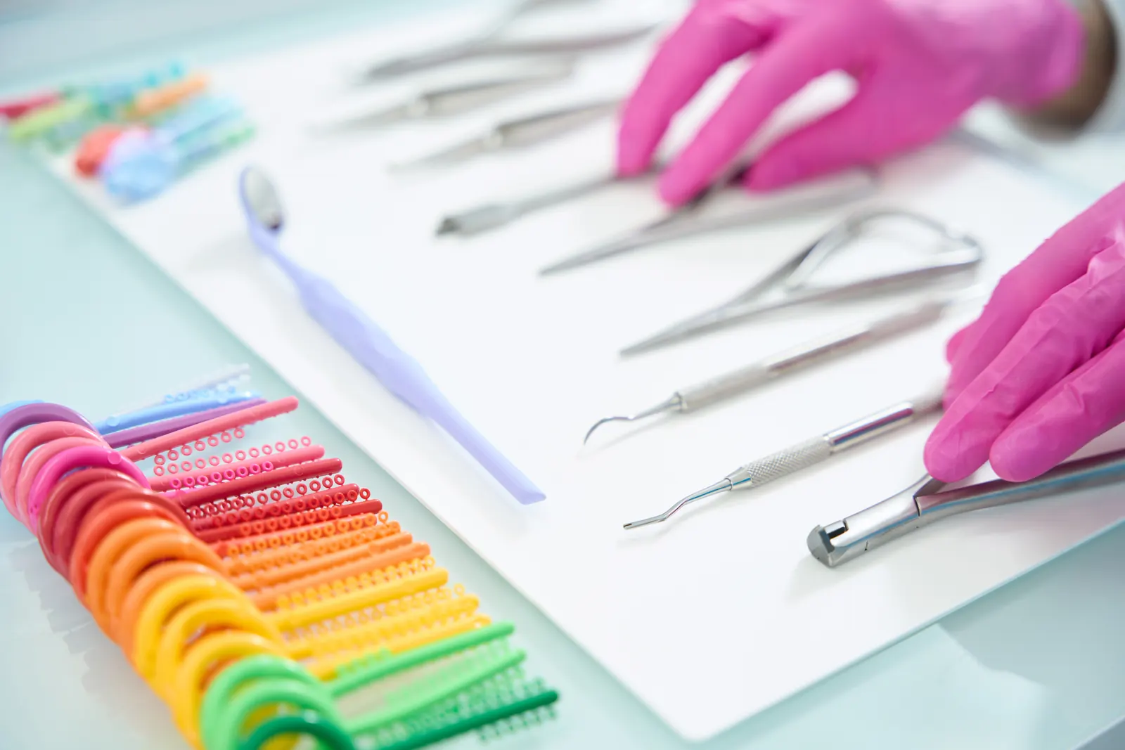 Dental accessories and colorful dental supplies on a white surface
